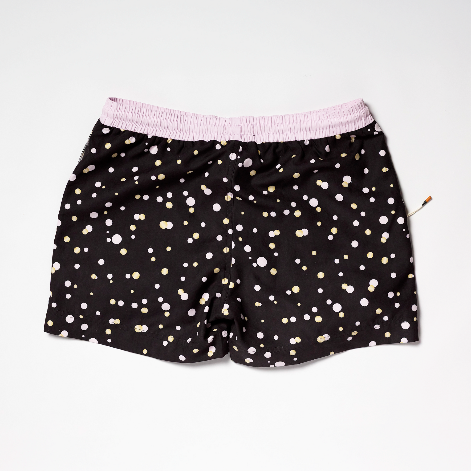 Designer Men’s Resort Wear, Swim Shorts & Luxury Swimwear Accessories | Riviera Bathers | Swim Trunks | Perlage | Black, Pink, and Gold Champagne Bubbles